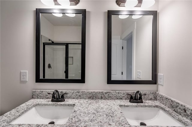 full bathroom with a stall shower and double vanity