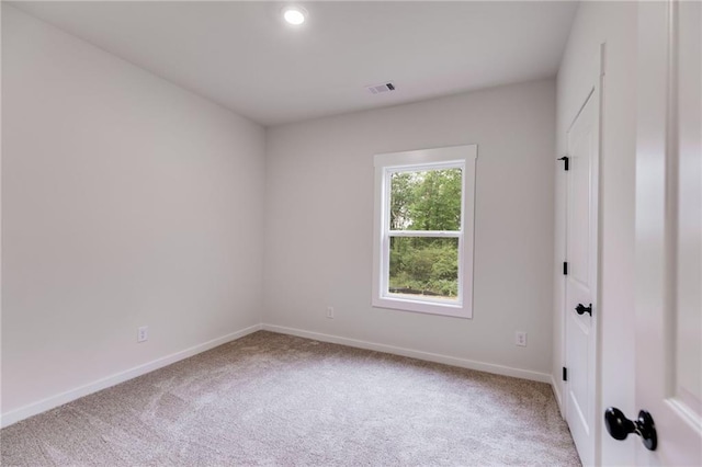 carpeted empty room featuring baseboards and recessed lighting