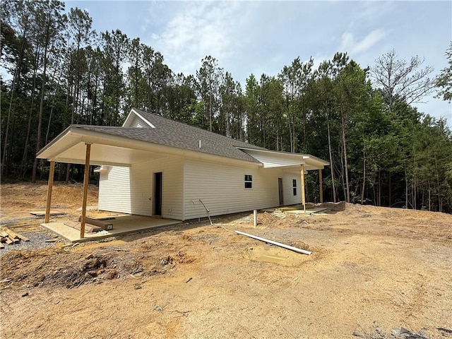 view of property exterior featuring a shingled roof