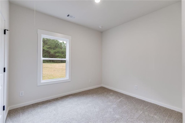 carpeted empty room with baseboards