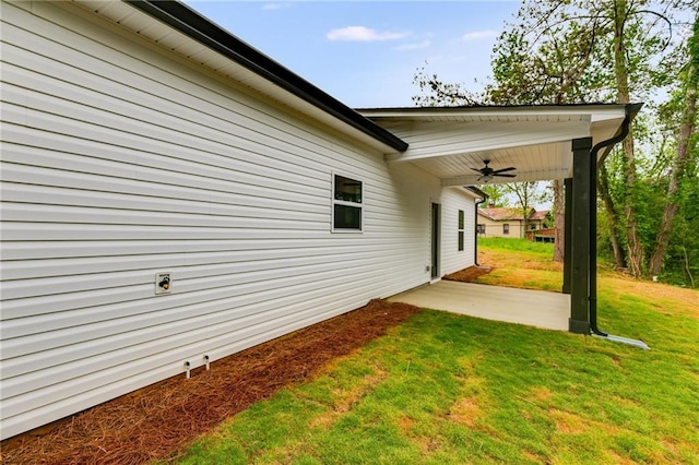 view of grassy yard with ceiling fan and a patio area