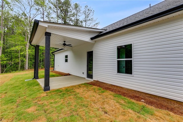 back of house with ceiling fan, a patio, and a yard