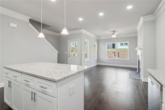 kitchen with pendant lighting, white cabinets, stainless steel dishwasher, ceiling fan, and light stone countertops