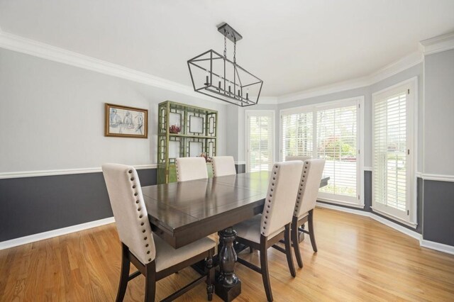 2689 Spring Rock Ct NE, Roswell, GA 30075 - dining space with a chandelier, light wood-style floors, ornamental molding, and healthy amount of natural light