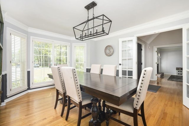2689 Spring Rock Ct NE, Roswell, GA 30075 - dining area featuring a chandelier, french doors, light wood finished floors, and ornamental molding