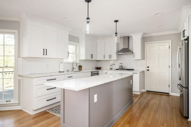 2689 Spring Rock Ct NE, Roswell, GA 30075 - kitchen featuring wall chimney exhaust hood, freestanding refrigerator, light wood-style flooring, white cabinetry, and decorative backsplash
