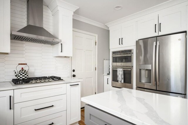 2689 Spring Rock Ct NE, Roswell, GA 30075 - kitchen with stainless steel appliances, wall chimney exhaust hood, crown molding, tasteful backsplash, and white cabinetry