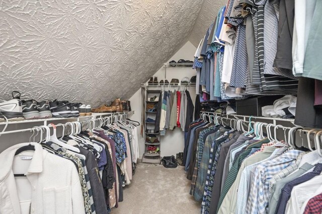 2689 Spring Rock Ct NE, Roswell, GA 30075 - walk in closet featuring carpet flooring and vaulted ceiling
