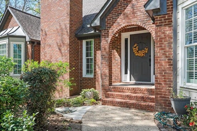 2689 Spring Rock Ct NE, Roswell, GA 30075 - view of exterior entry featuring brick siding, a shingled roof, and a chimney