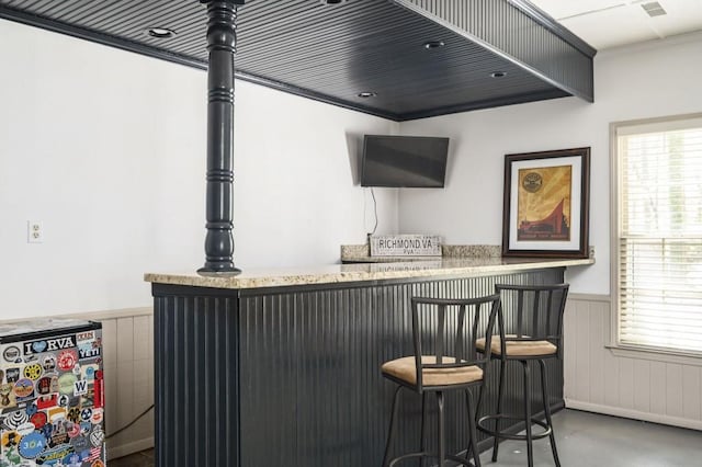 2689 Spring Rock Ct NE, Roswell, GA 30075 - indoor dry bar with a wainscoted wall and finished concrete flooring