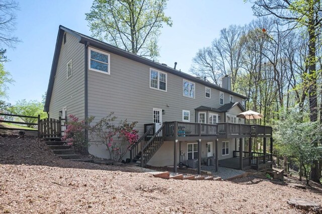 2689 Spring Rock Ct NE, Roswell, GA 30075 - rear view of house with stairs, a chimney, a wooden deck, and a patio area