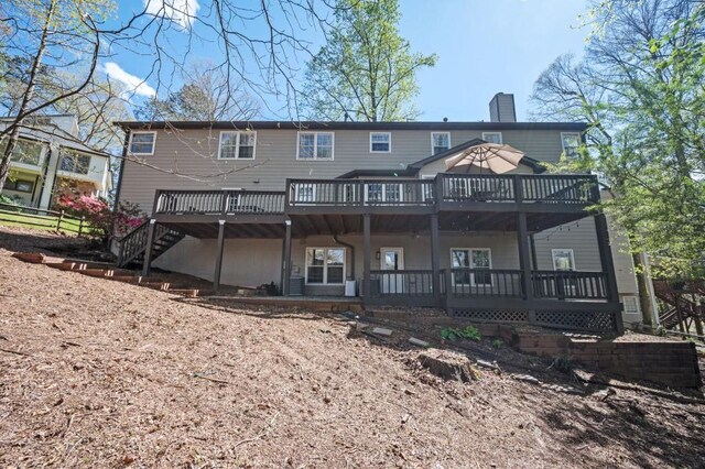 2689 Spring Rock Ct NE, Roswell, GA 30075 - back of house with a wooden deck, a chimney, and stairs