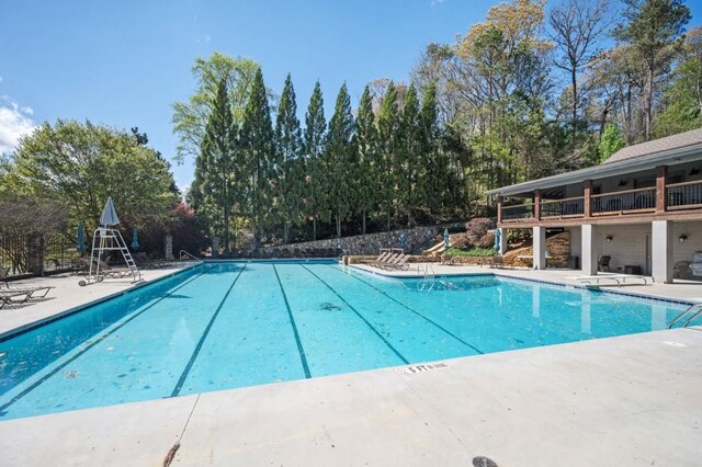 2689 Spring Rock Ct NE, Roswell, GA 30075 - community pool featuring a patio area and view of scattered trees