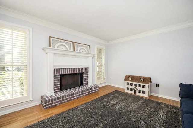 2689 Spring Rock Ct NE, Roswell, GA 30075 - living area featuring ornamental molding, wood finished floors, plenty of natural light, and a brick fireplace