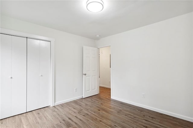329 Cranfill Rd SE, Marietta, GA 30060 - unfurnished bedroom featuring baseboards, wood finished floors, and a closet
