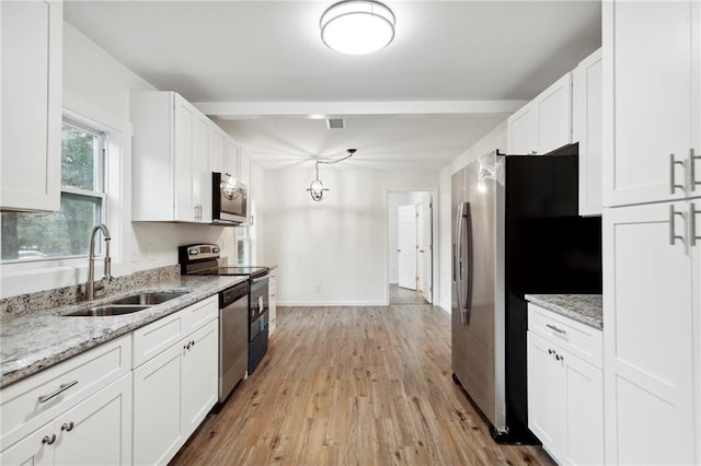 329 Cranfill Rd SE, Marietta, GA 30060 - kitchen with a sink, stainless steel appliances, white cabinets, and light wood-style floors