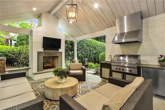 view of patio / terrace with an outdoor kitchen, a grill, sink, and an outdoor living space with a fireplace