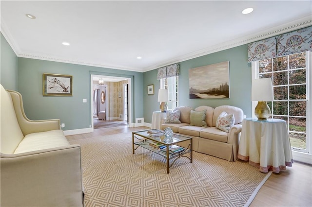 living room with crown molding and light hardwood / wood-style flooring