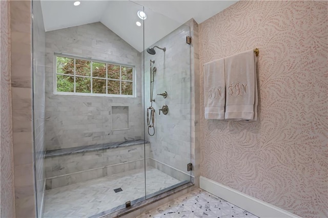 bathroom featuring lofted ceiling and a shower with door