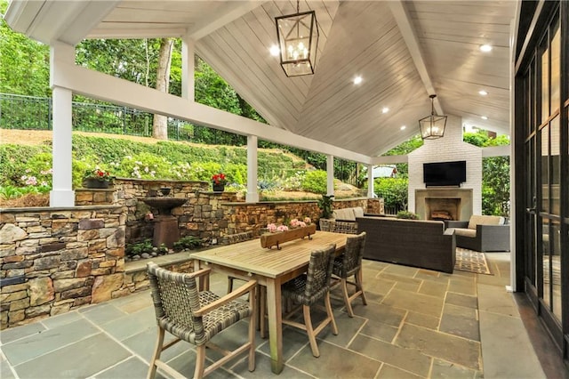 view of patio featuring an outdoor living space with a fireplace