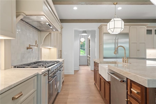384 Hickory Pass, Alpharetta, GA 30004 - kitchen with premium appliances, a sink, light wood-style flooring, decorative backsplash, and decorative light fixtures