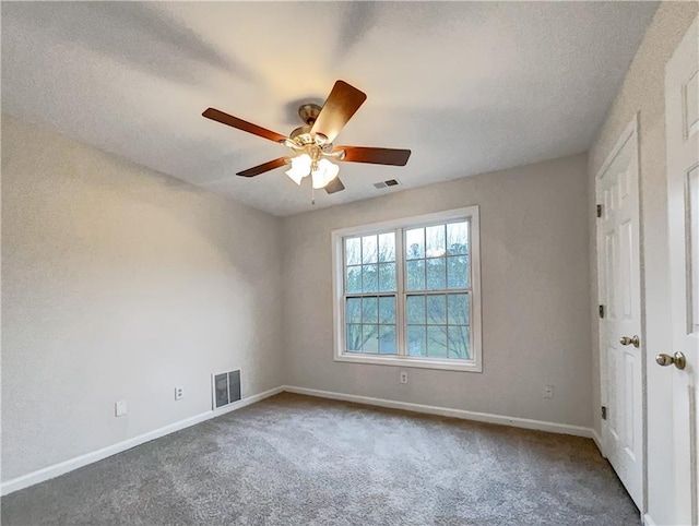 carpeted spare room featuring ceiling fan