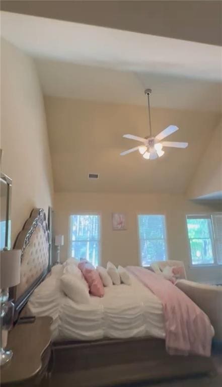bedroom with high vaulted ceiling and a ceiling fan