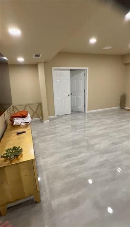 basement with baseboards and recessed lighting