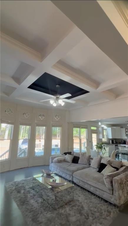 living room with coffered ceiling, ceiling fan, and beam ceiling