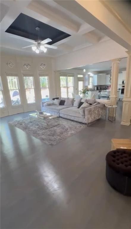 living area with coffered ceiling, decorative columns, a ceiling fan, beam ceiling, and wood finished floors