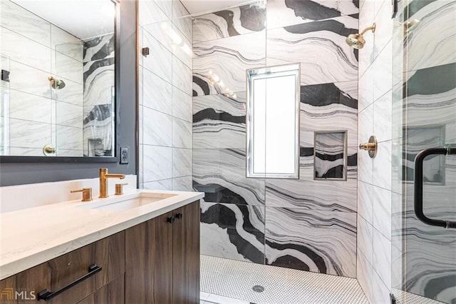 bathroom featuring vanity and a shower with door