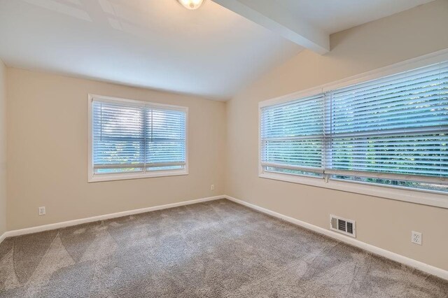 spare room with lofted ceiling with beams and carpet floors