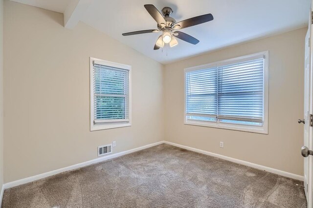 carpeted spare room featuring ceiling fan and lofted ceiling with beams