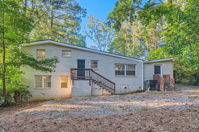 rear view of house featuring central air condition unit