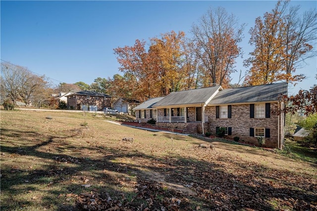 exterior space featuring a lawn and covered porch