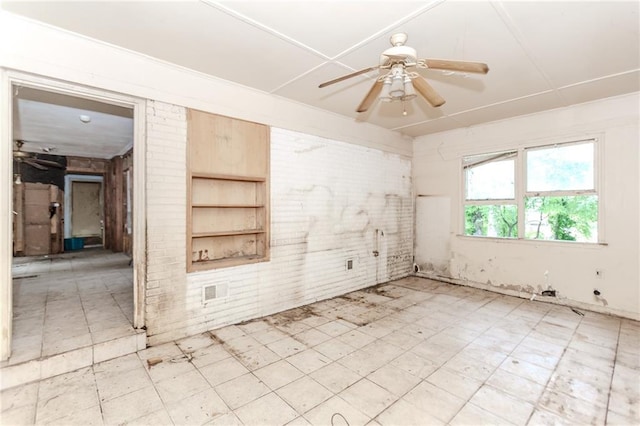 empty room with a ceiling fan and light flooring