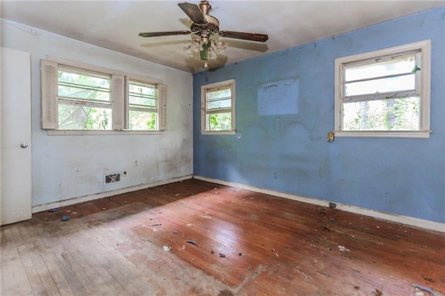 spare room featuring hardwood / wood-style flooring, baseboards, and a ceiling fan