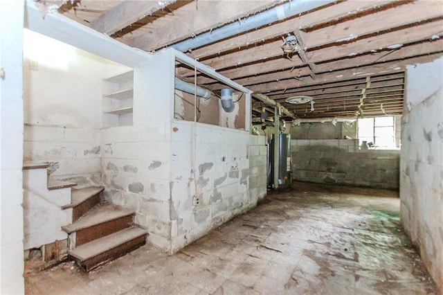 basement with water heater and stairs