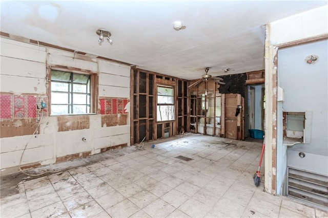 unfurnished room featuring plenty of natural light and ceiling fan