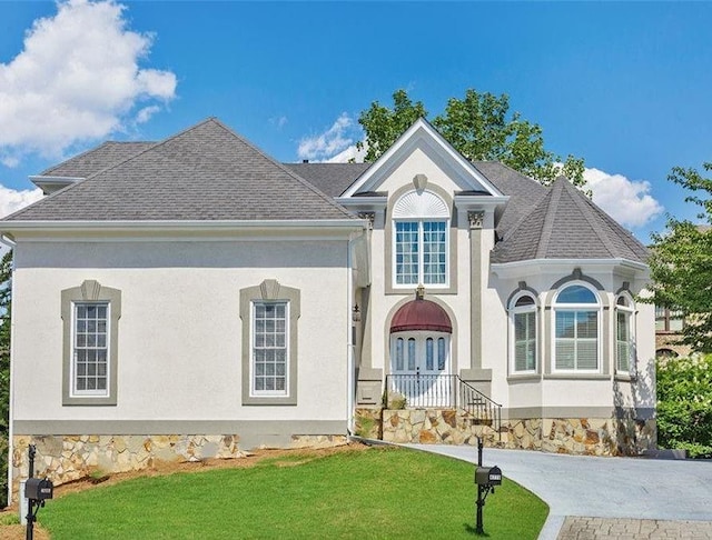 4770 Powers Park Ct NE, Marietta, GA 30067 - view of front of house featuring a front yard, a shingled roof, french doors, and stucco siding
