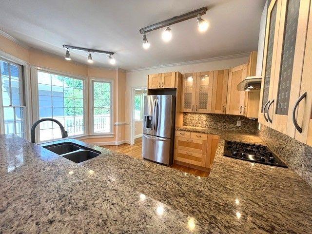 4770 Powers Park Ct NE, Marietta, GA 30067 - kitchen with stainless steel refrigerator with ice dispenser, black gas stovetop, a sink, dark stone countertops, and glass insert cabinets