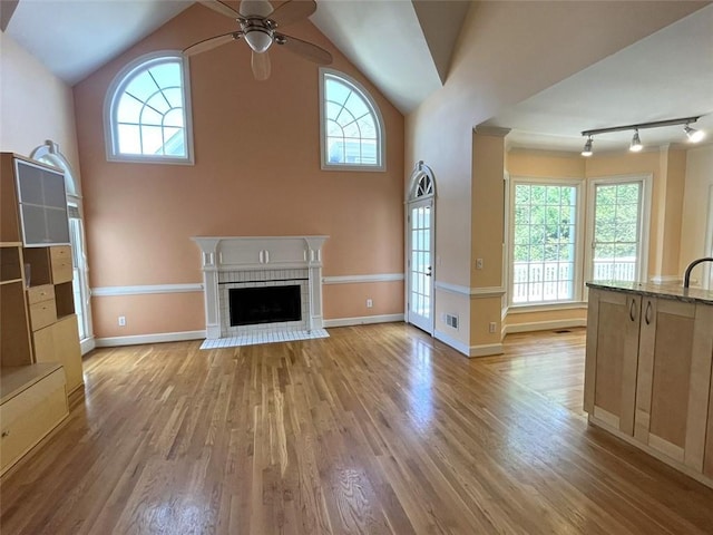 4770 Powers Park Ct NE, Marietta, GA 30067 - unfurnished living room featuring ceiling fan, plenty of natural light, light wood-style floors, and vaulted ceiling