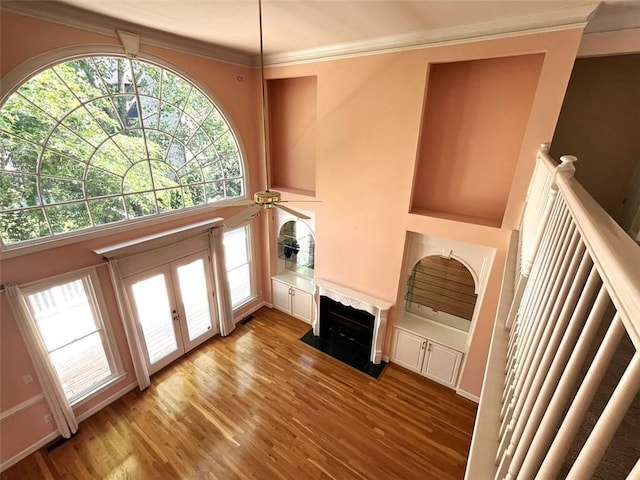 4770 Powers Park Ct NE, Marietta, GA 30067 - unfurnished living room with light wood-style flooring, crown molding, a ceiling fan, a high end fireplace, and french doors