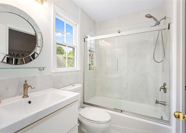 4770 Powers Park Ct NE, Marietta, GA 30067 - full bath featuring toilet, shower / bath combination with glass door, vanity, and tile walls