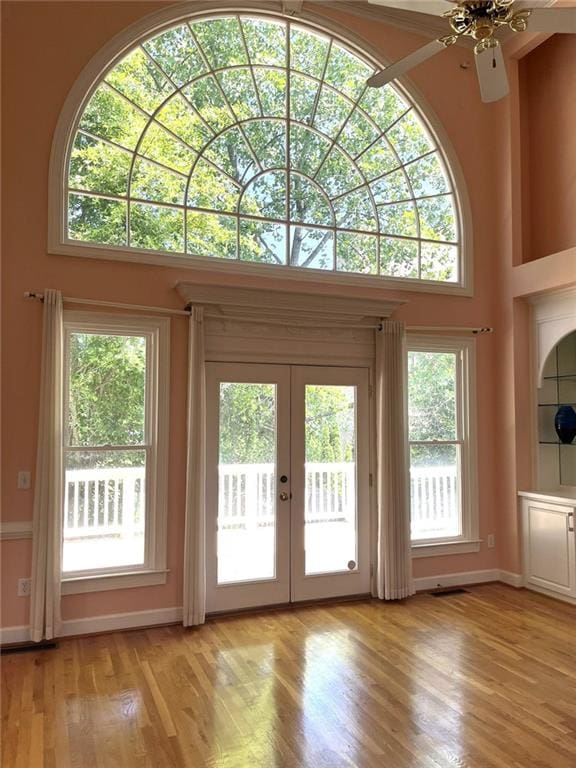 4770 Powers Park Ct NE, Marietta, GA 30067 - entryway with french doors, light wood-type flooring, a ceiling fan, baseboards, and a high ceiling
