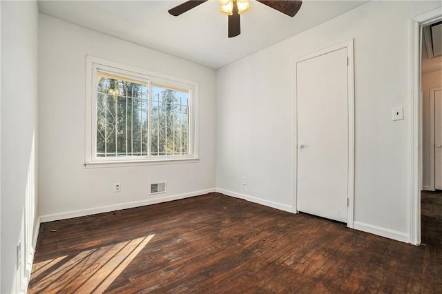 unfurnished bedroom featuring ceiling fan and dark wood-type flooring