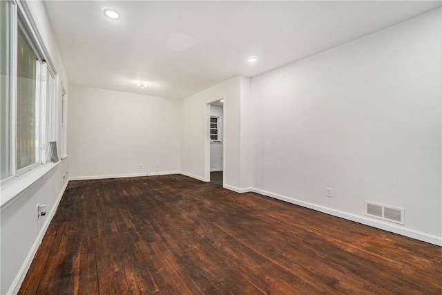 spare room with dark wood-type flooring