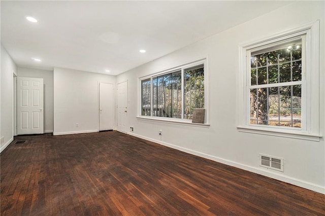 empty room with dark hardwood / wood-style floors