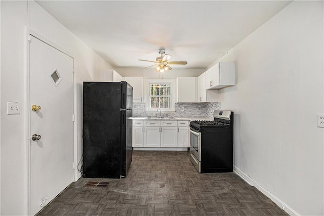 kitchen featuring sink, white cabinetry, black refrigerator, dark parquet floors, and gas range