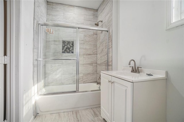 bathroom with vanity and combined bath / shower with glass door